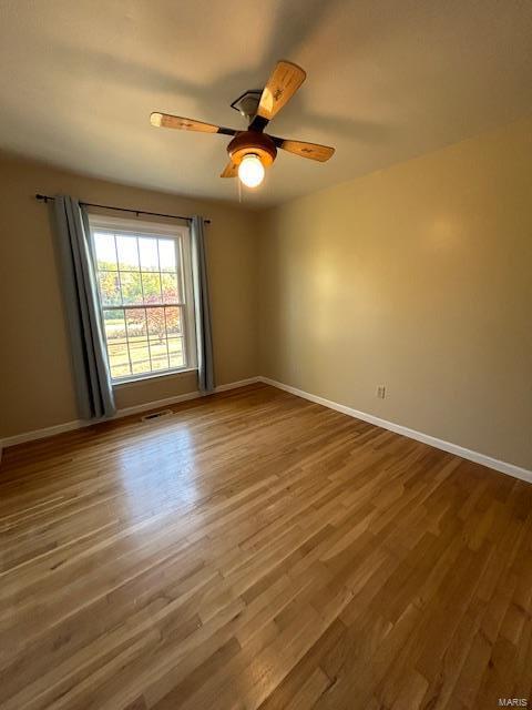 13825 Old Wire Outer Rd, Rolla, MO 65401 - empty room featuring wood finished floors, baseboards, and ceiling fan