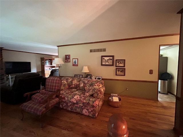living room featuring ornamental molding and wood finished floors