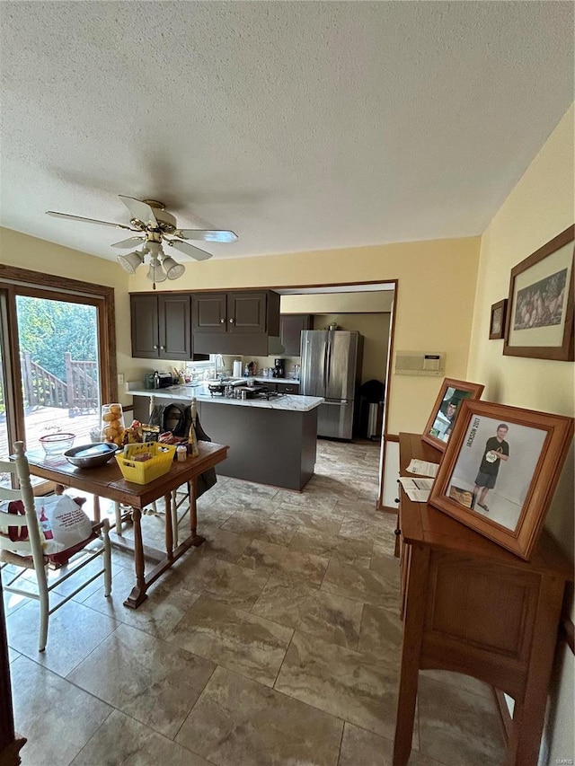 dining room featuring a textured ceiling and ceiling fan
