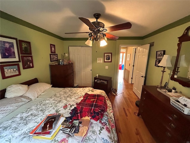 bedroom with wood finished floors, a closet, and a ceiling fan