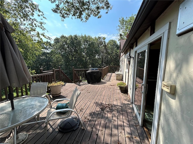 wooden deck with outdoor dining space