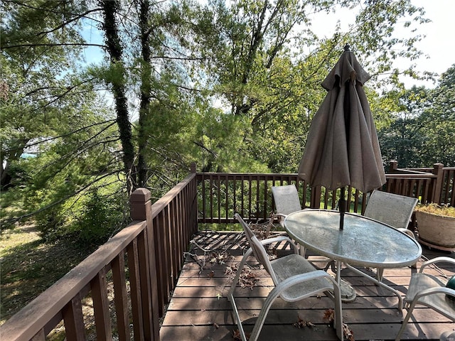 wooden deck featuring outdoor dining area