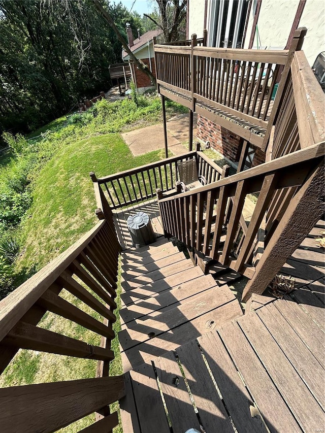 wooden deck featuring a lawn