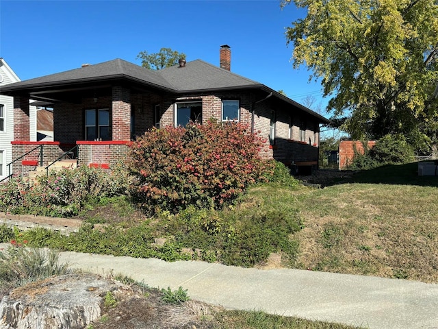 203 W Booneslick Rd, Warrenton, MO 63383 - view of side of home featuring brick siding, a chimney, and a yard