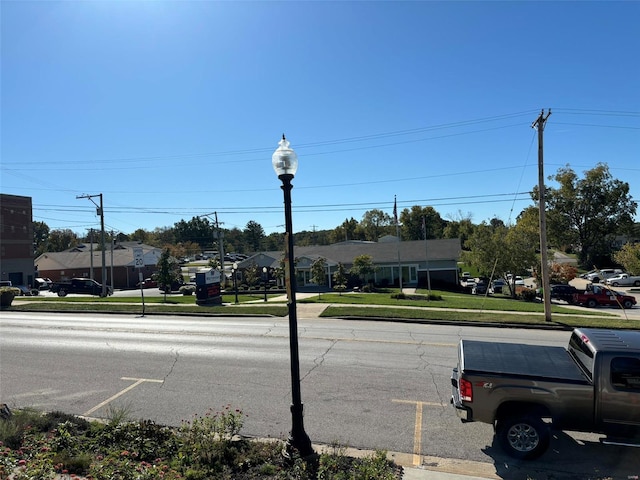 203 W Booneslick Rd, Warrenton, MO 63383 - view of asphalt road featuring sidewalks, street lighting, curbs, and a residential view