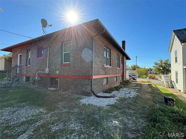 203 W Booneslick Rd, Warrenton, MO 63383 - view of home's exterior with a chimney and brick siding