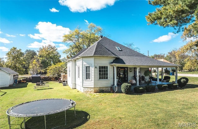 401 W Gibbs, Salem, MO 65560 - rear view of house with a trampoline, a lawn, roof with shingles, and covered porch
