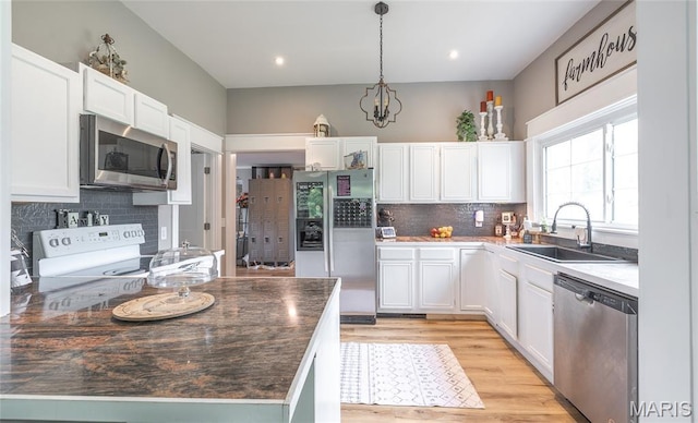 401 W Gibbs, Salem, MO 65560 - kitchen with appliances with stainless steel finishes, white cabinetry, decorative backsplash, decorative light fixtures, and recessed lighting