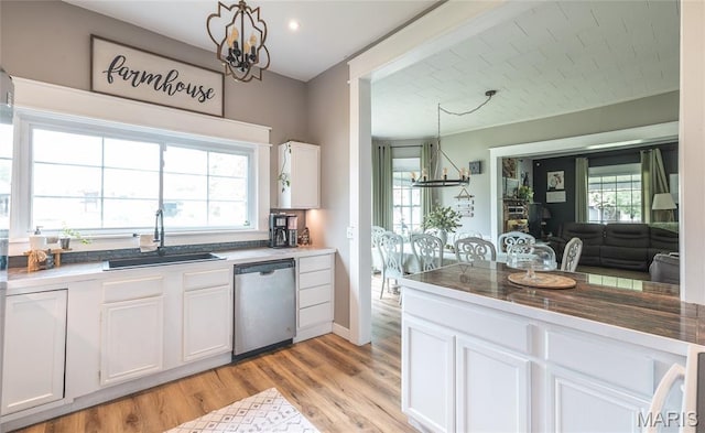 401 W Gibbs, Salem, MO 65560 - kitchen with stainless steel dishwasher, a chandelier, white cabinets, and light wood finished floors