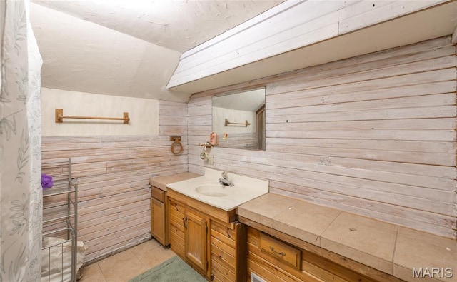 401 W Gibbs, Salem, MO 65560 - bathroom with lofted ceiling, vanity, wooden walls, and tile patterned floors