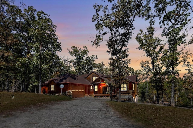 11336 Choctaw Cir, Saint Genevieve, MO 63670 - chalet / cabin featuring dirt driveway and an attached garage