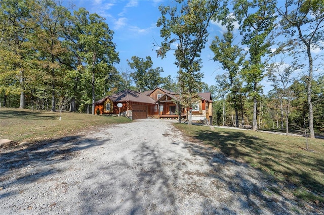 11336 Choctaw Cir, Saint Genevieve, MO 63670 - view of front of house featuring driveway, a garage, and a front lawn