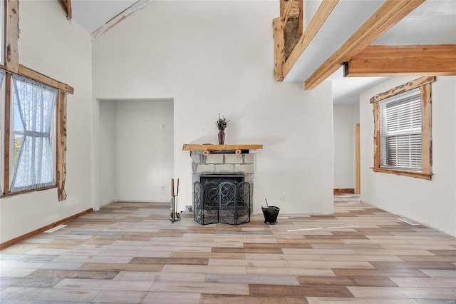 11336 Choctaw Cir, Saint Genevieve, MO 63670 - unfurnished living room with high vaulted ceiling, a fireplace, beamed ceiling, and wood finished floors