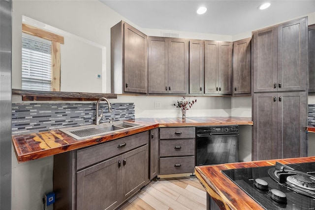 11336 Choctaw Cir, Saint Genevieve, MO 63670 - kitchen with a sink, black cooktop, butcher block counters, tasteful backsplash, and light wood finished floors