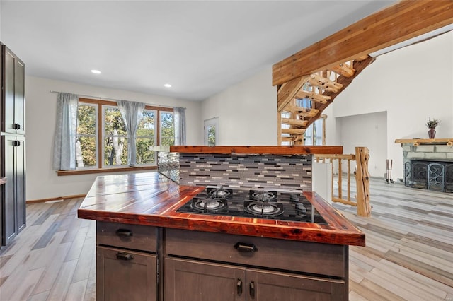 11336 Choctaw Cir, Saint Genevieve, MO 63670 - kitchen featuring black gas cooktop, light wood-style flooring, recessed lighting, dark brown cabinetry, and a fireplace