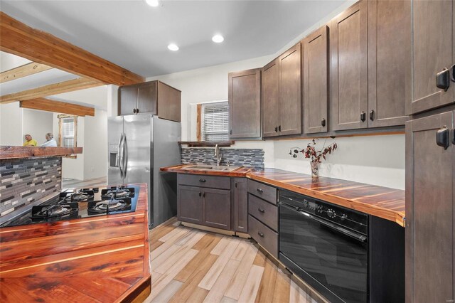11336 Choctaw Cir, Saint Genevieve, MO 63670 - kitchen with black appliances, butcher block counters, a sink, light wood finished floors, and decorative backsplash