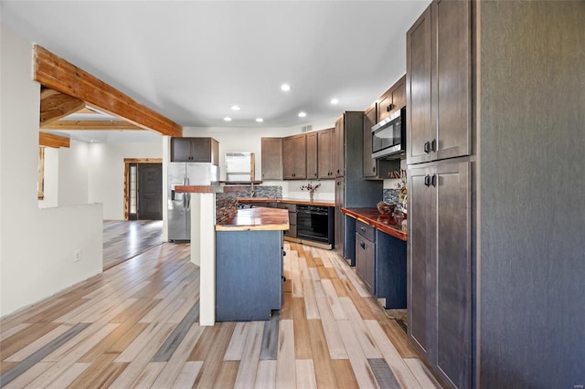 11336 Choctaw Cir, Saint Genevieve, MO 63670 - kitchen with appliances with stainless steel finishes, light wood finished floors, recessed lighting, wooden counters, and dark brown cabinetry