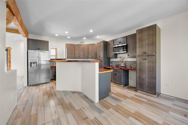 11336 Choctaw Cir, Saint Genevieve, MO 63670 - kitchen with stainless steel appliances, light wood finished floors, recessed lighting, decorative backsplash, and a center island