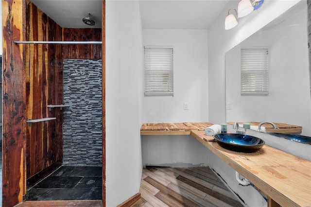 11336 Choctaw Cir, Saint Genevieve, MO 63670 - bathroom with a sink, tiled shower, and wood finished floors