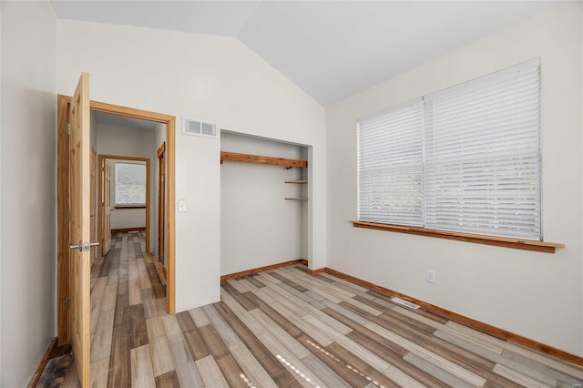11336 Choctaw Cir, Saint Genevieve, MO 63670 - unfurnished bedroom with lofted ceiling, wood finished floors, a closet, and baseboards
