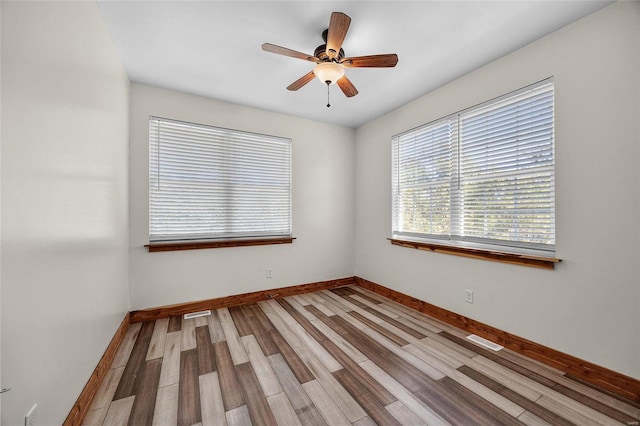 11336 Choctaw Cir, Saint Genevieve, MO 63670 - empty room with wood finished floors, baseboards, and a ceiling fan