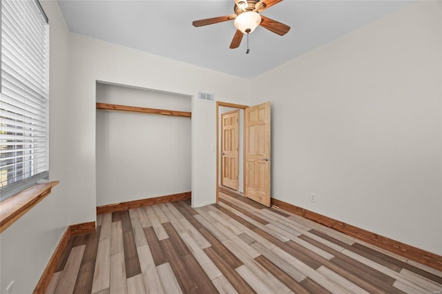 11336 Choctaw Cir, Saint Genevieve, MO 63670 - unfurnished bedroom with wood finished floors, a closet, baseboards, and ceiling fan