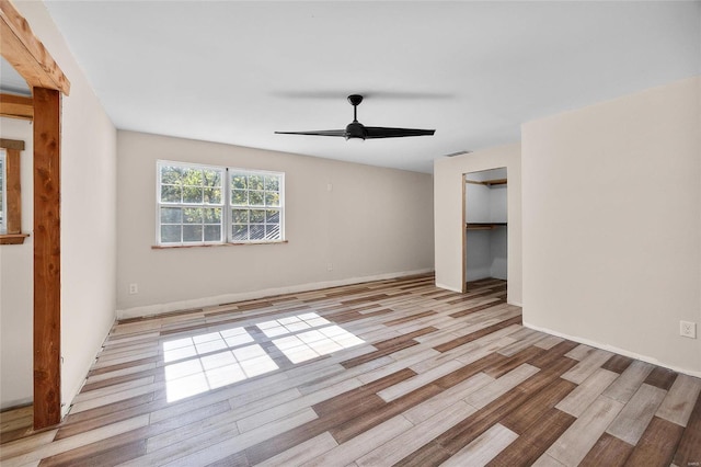 11336 Choctaw Cir, Saint Genevieve, MO 63670 - unfurnished living room featuring a ceiling fan, wood finished floors, and baseboards
