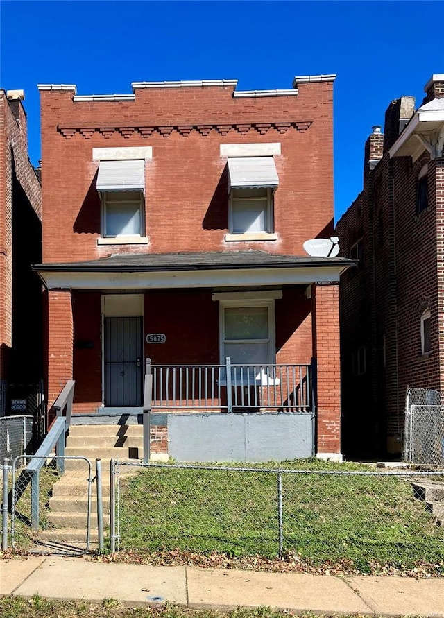 5875 Lotus Ave, Saint Louis, MO 63112 - view of front of house with brick siding, a porch, a fenced front yard, and a gate