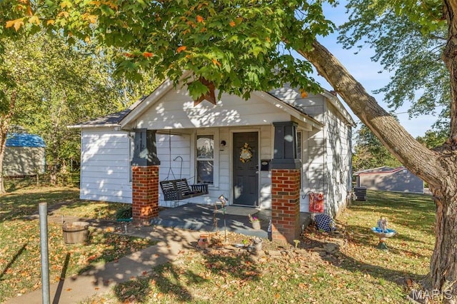 32 Summit St, Bonne Terre, MO 63628 - view of front of property with a porch, brick siding, and a front yard