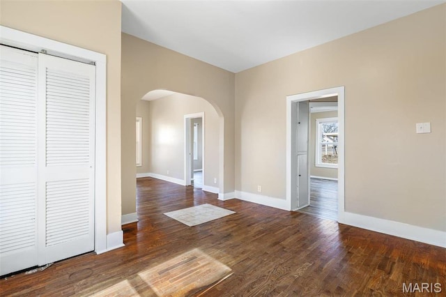 32 Summit St, Bonne Terre, MO 63628 - spare room with arched walkways, baseboards, and wood finished floors