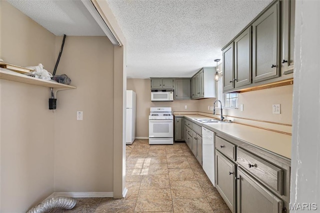 32 Summit St, Bonne Terre, MO 63628 - kitchen featuring white appliances, a sink, baseboards, a textured ceiling, and light countertops