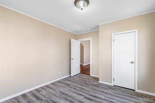 32 Summit St, Bonne Terre, MO 63628 - unfurnished bedroom featuring wood finished floors, baseboards, ornamental molding, and arched walkways