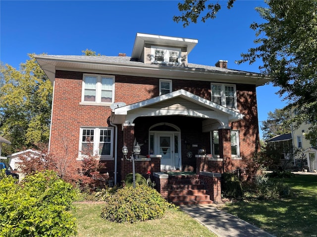traditional style home featuring brick siding and a chimney