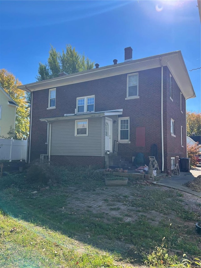rear view of house with brick siding