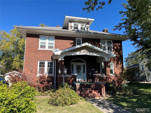 611 W Main St, Staunton, IL 62088 - american foursquare style home with brick siding, a chimney, and a porch