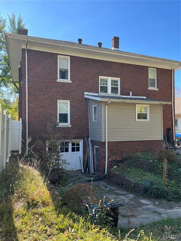611 W Main St, Staunton, IL 62088 - rear view of house with a chimney and brick siding