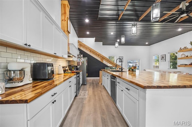 10410 Business 21, Hillsboro, MO 63050 - kitchen with butcher block countertops, a sink, appliances with stainless steel finishes, light wood-type flooring, and tasteful backsplash