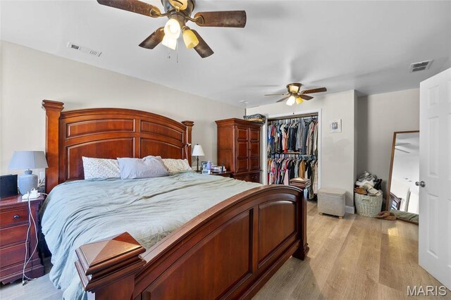 10410 Business 21, Hillsboro, MO 63050 - bedroom featuring light wood finished floors, a closet, ceiling fan, and a spacious closet