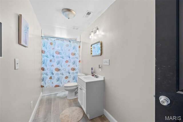 10410 Business 21, Hillsboro, MO 63050 - bathroom with wood finished floors, vanity, baseboards, toilet, and shower / bath combo