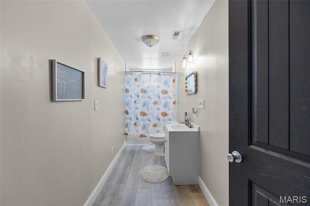10410 Business 21, Hillsboro, MO 63050 - full bathroom featuring wood finished floors, toilet, baseboards, vanity, and a shower with curtain