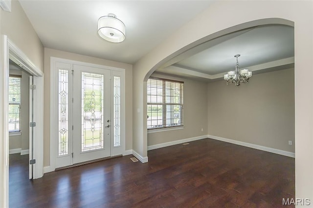 612 Savannah View Way, Chesterfield, MO 63017 - foyer entrance with arched walkways, a chandelier, wood finished floors, and baseboards