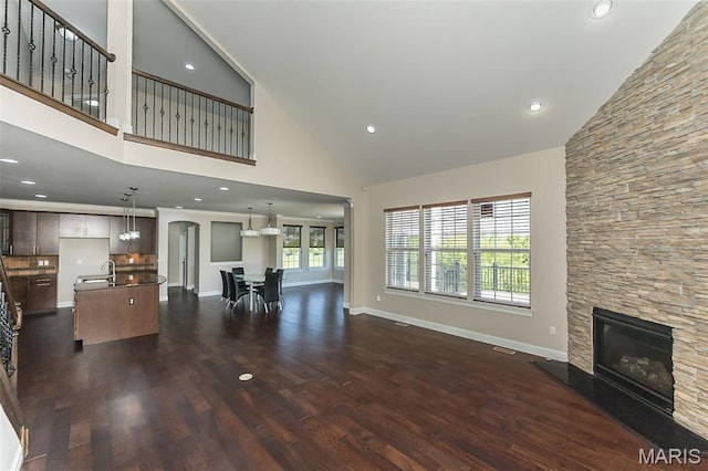 612 Savannah View Way, Chesterfield, MO 63017 - living room featuring high vaulted ceiling, a stone fireplace, dark wood finished floors, baseboards, and recessed lighting