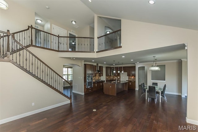612 Savannah View Way, Chesterfield, MO 63017 - living area featuring dark wood-style floors, arched walkways, baseboards, stairway, and recessed lighting