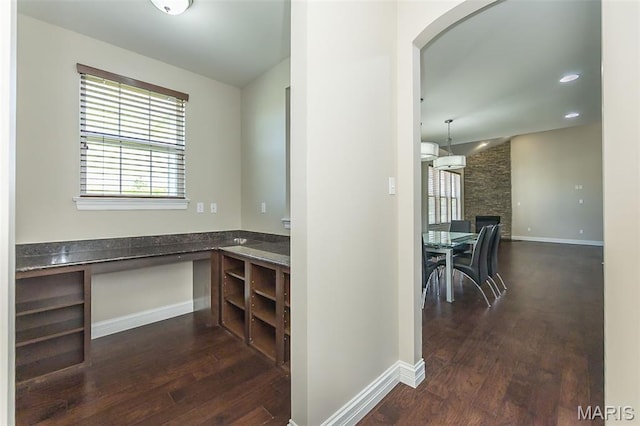612 Savannah View Way, Chesterfield, MO 63017 - unfurnished office with dark wood finished floors, arched walkways, a stone fireplace, and baseboards