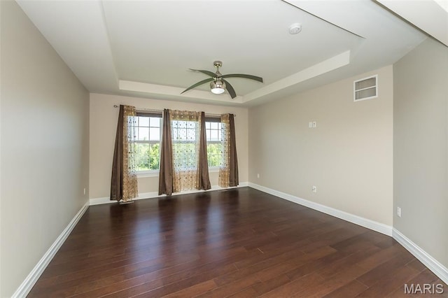 612 Savannah View Way, Chesterfield, MO 63017 - empty room featuring a raised ceiling, ceiling fan, dark wood-type flooring, and baseboards