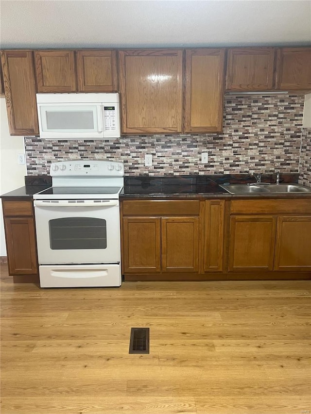 29379 Trails End Unit A & B, Wright City, MO 63390 - kitchen with white appliances, a sink, dark countertops, and decorative backsplash