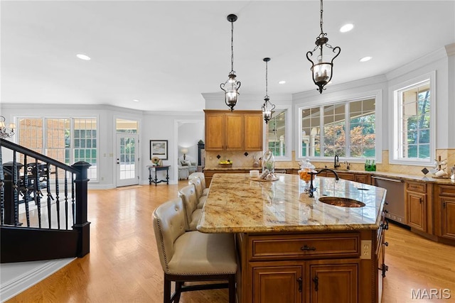 1 Claychester Dr, Saint Louis, MO 63131 - kitchen with dishwasher, brown cabinetry, ornamental molding, a sink, and recessed lighting