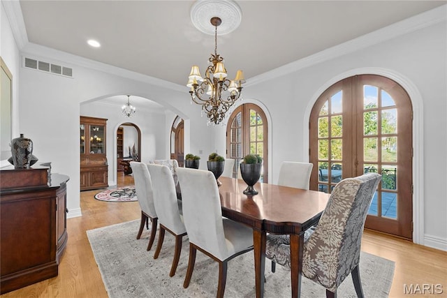1 Claychester Dr, Saint Louis, MO 63131 - dining space featuring arched walkways, a chandelier, light wood-style flooring, crown molding, and recessed lighting