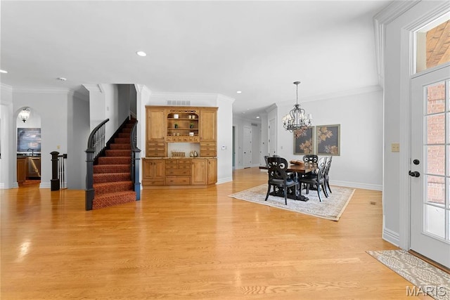 1 Claychester Dr, Saint Louis, MO 63131 - dining space with crown molding, stairway, light wood finished floors, baseboards, and a chandelier