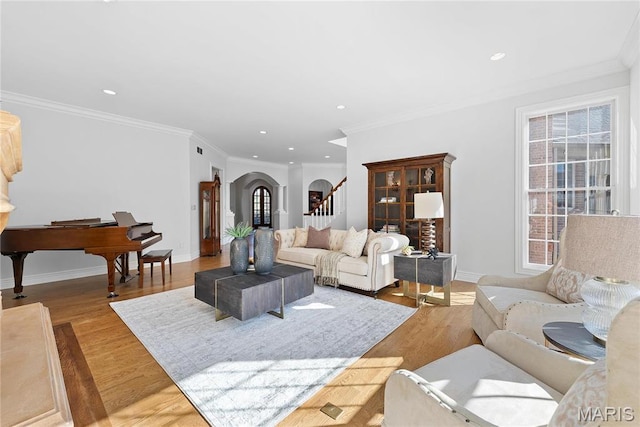 1 Claychester Dr, Saint Louis, MO 63131 - living room with arched walkways, stairway, light wood finished floors, baseboards, and recessed lighting